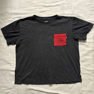 Kids short sleeve Vans shirt size Large with a red pocket and writing
